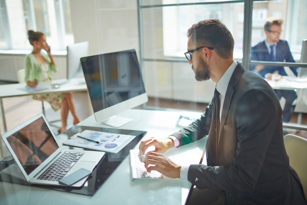man in an office working in his computer