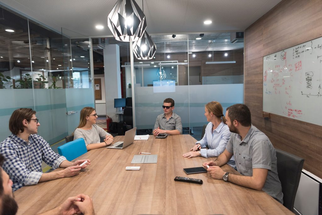 Startup colleagues reviewing strategy together during an informal meeting.