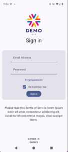 Screenshot of the demo app, taken on an Android phone in portrait mode. The app consists of components that are typically found on an app's home screen (from top to bottom): simple colorful logo with 'Demo app' text, 'Sign in' heading, email address and password fields, 'Forgot password' link, 'Remember me' checkbox, dark blue 'Sign in' button, some terms and conditions text, and a couple of footer links.